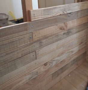 Pictured is interior wall cladding from recycled planks
