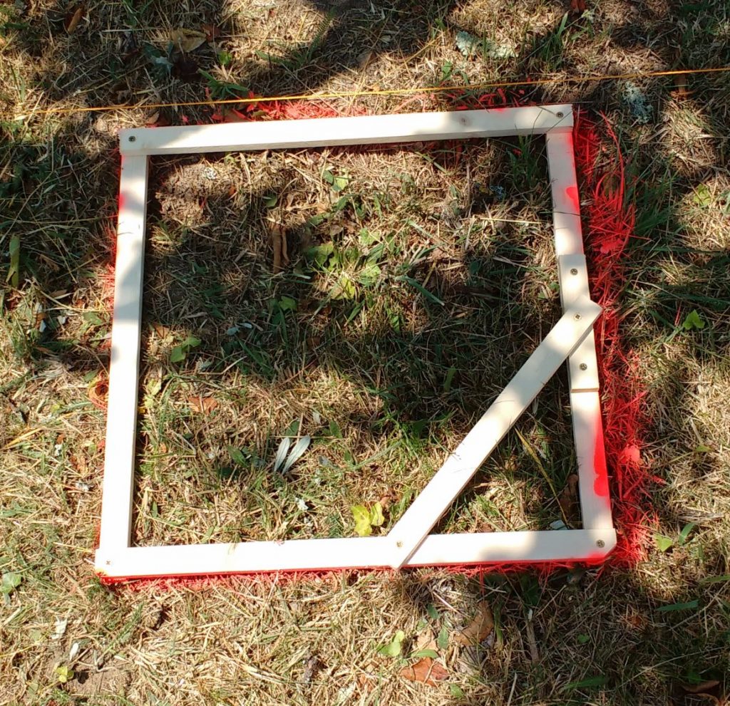 Pictured is a square wooden frame for marking foundation pads