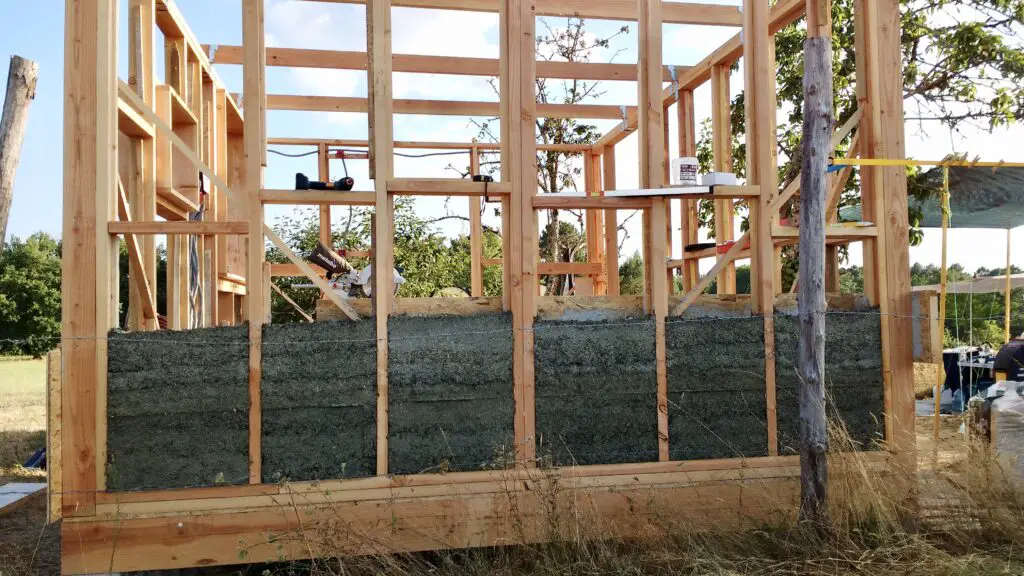Pictured is a timber framed house partially insulated with hempcrete