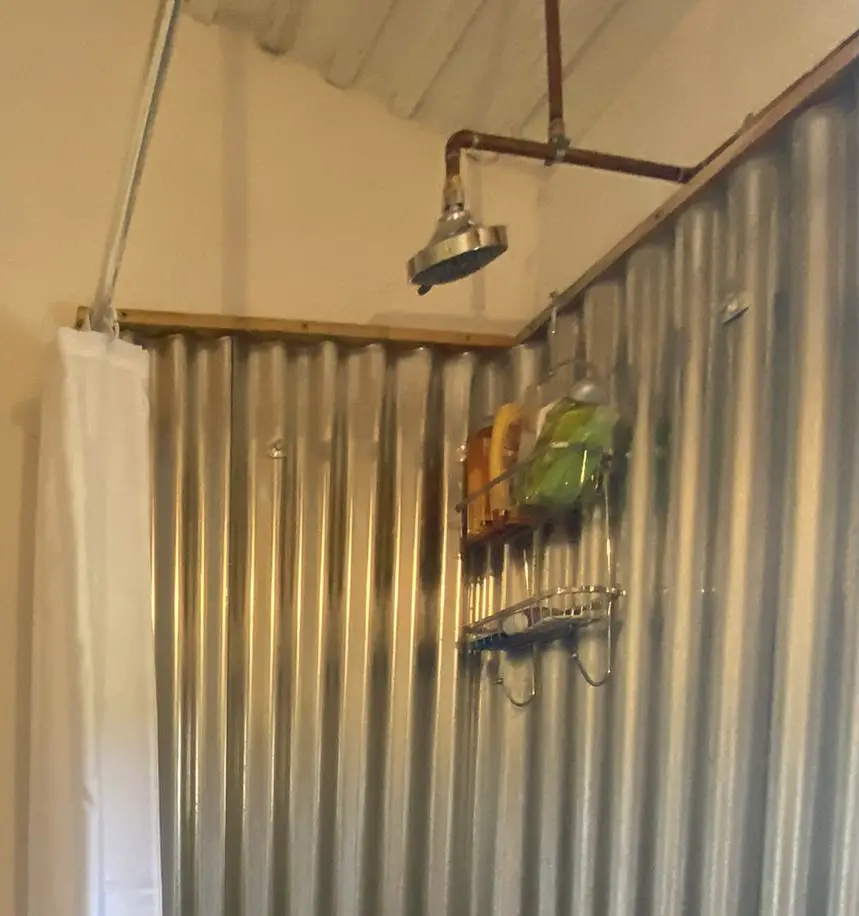 Pictured is a shower using corrugated steel panels