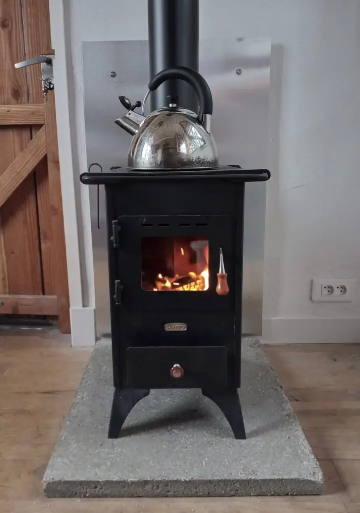 Pictured is the Prity mini with hearth and wall shield.  This wood burner and flue system cost less than £700.
