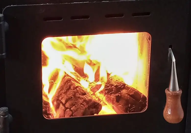 Pictured is a close up of wood burning in a stove