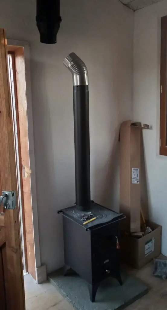 Pictured is the wood burner mid-installation